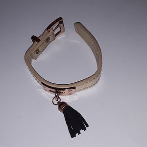 Gold bracelet with black tassel
